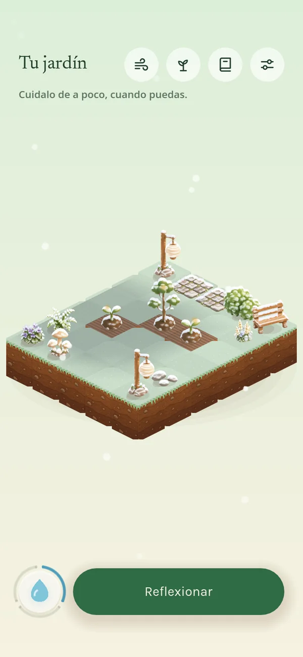 El mismo jardín en invierno, con nieve sobre las plantas y los faroles